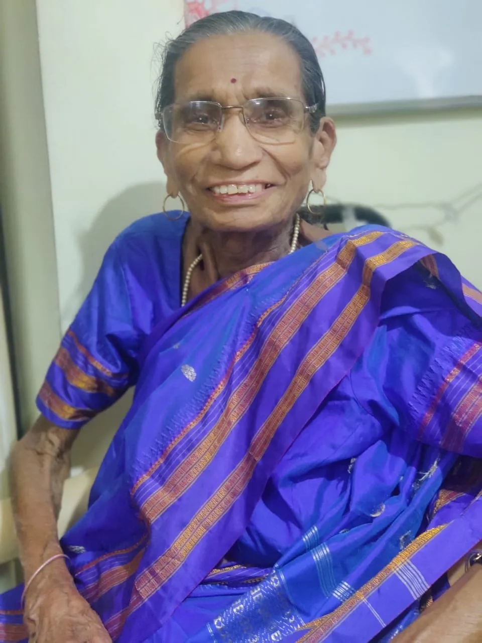 Joyful elderly lady showing her artwork